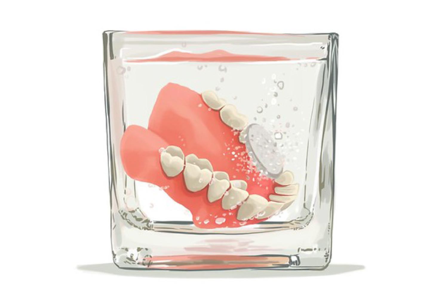 Dentures sitting in a cup getting cleaned.