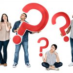 Diverse group of people hold up big red question marks as they think of questions to ask their dental hygienist