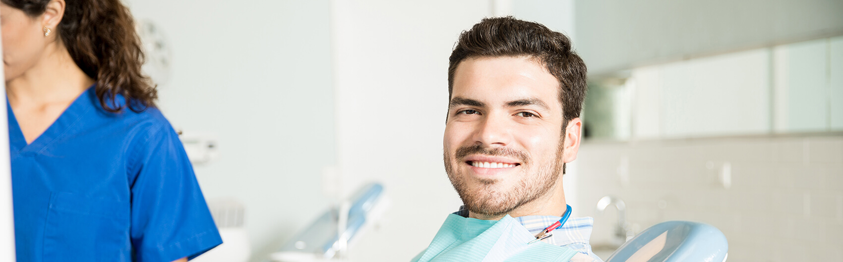 smiling man sitting in a dental chair