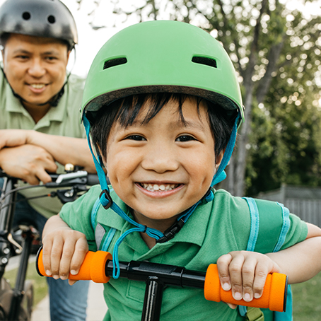 smiling child on bicycle